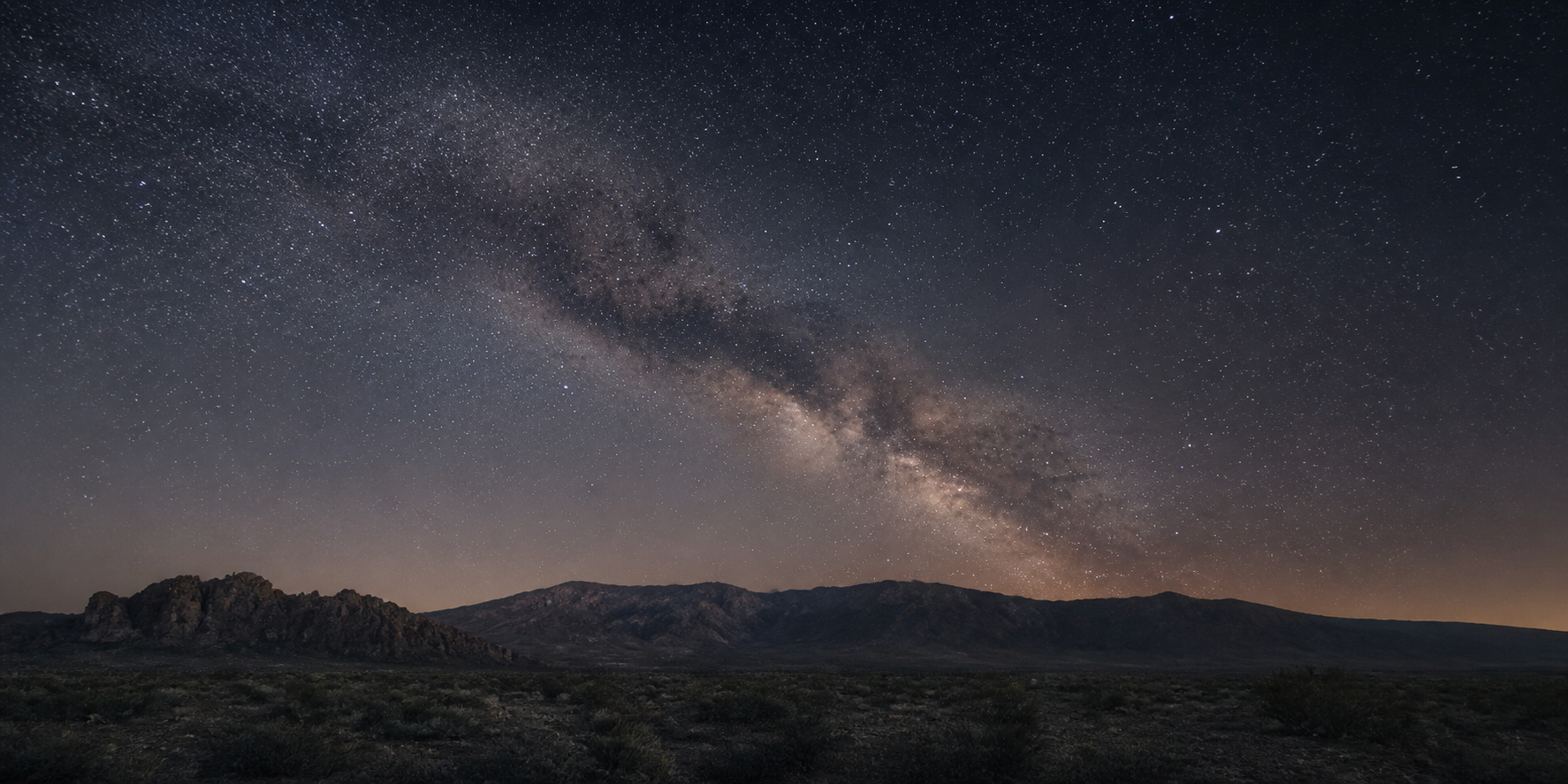 The Milky Way above a quiet mountain landscape.